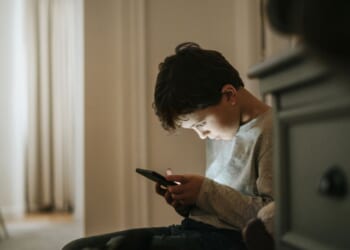 A boy playing video games at home.