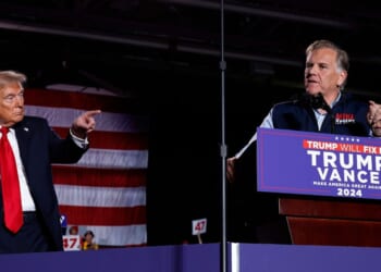 Republican Senate candidate Mike Rogers joins President Donald Trump on stage during a campaign rally at Macomb Community College on Nov. 1, 2024, in Warren, Michigan.