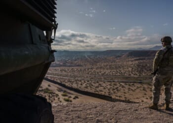 A U.S. Army soldier stands next to a Stryker armored infantry transport vehicle, which has been deployed along the Mexican border as part of the military's Joint Task Force Southern Border mission, in Sunland Park, New Mexico, on April 4, 2025.