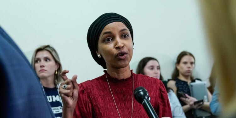 Rep. Ilhan Omar speaks to reporters in the hallway outside a House Committee on Education and the Workforce hearing "Columbia in Crisis: Columbia University's Response to Anti-Semitism" at Capitol Hill in Washington, D.C., on April 17, 2024.