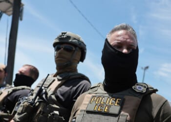 ICE agents stand guard in front of protesters outside Delaney Hall, which is being used as an Immigration and Customs Enforcement detention center, on May 26, 2026, in Newark, New Jersey.