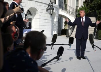 President Donald Trump speaks to members of the media before a South Lawn departure at the White House on Oct. 2.