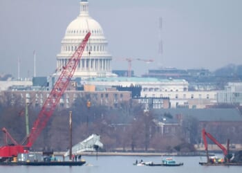 A crane lifts a piece of American Airlines flight 5342 from the Potomac River during recovery efforts on Feb. 3, 2025, in Arlington, Virginia. An American Airlines flight from Wichita, Kansas collided midair with a military Black Hawk helicopter while on approach to Ronald Reagan Washington National Airport outside of Washington, D.C., on Jan. 29, 2025 .