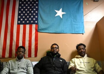 Patrons watch a soccer game as they sit under an American and Somali flag at a cafe inside 24 Somali Mall on Dec. 2, 2025, in Minneapolis, Minnesota.