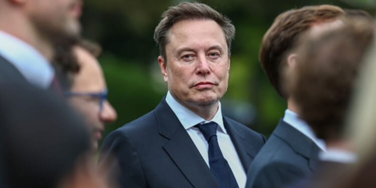 Elon Musk looks at photographers as he visits the White House for an AI conference on September 29, 2026.
