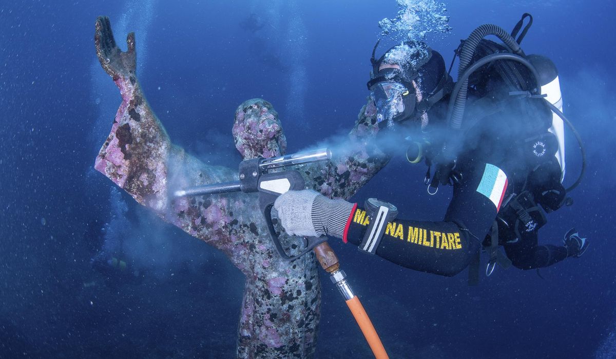 Italian divers water-blast the popular underwater statue of Christ off Portofino