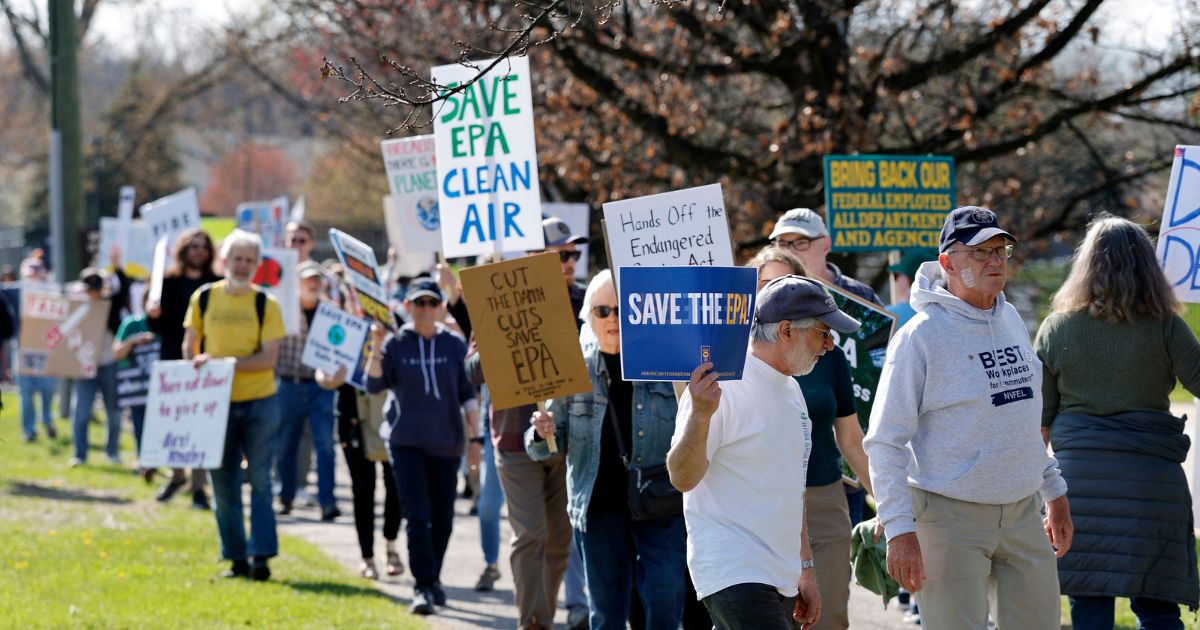 Demonstrators march during a "Hands off the EPA" rally outside the EPA offices in Ann Arbor, Michigan, on Earth Day, April 22, 2025.