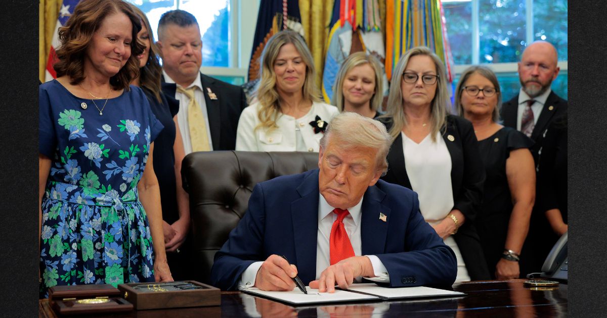 President Donald Trump signs a proclamation Monday, on the fourth anniversary of the Abbey Gate terrorist attack in Kabul, Afghanistan. He was joined by family members of the 13 U.S. service members who were killed in the attack during the Biden administration's disastrous withdrawal from the country.