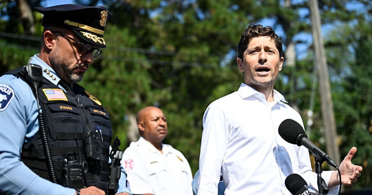 Minneapolis Mayor Jacob Frey, right, speaks to the media following a mass shooting at Annunciation Catholic Church Wednesday in Minneapolis, Minnesota.