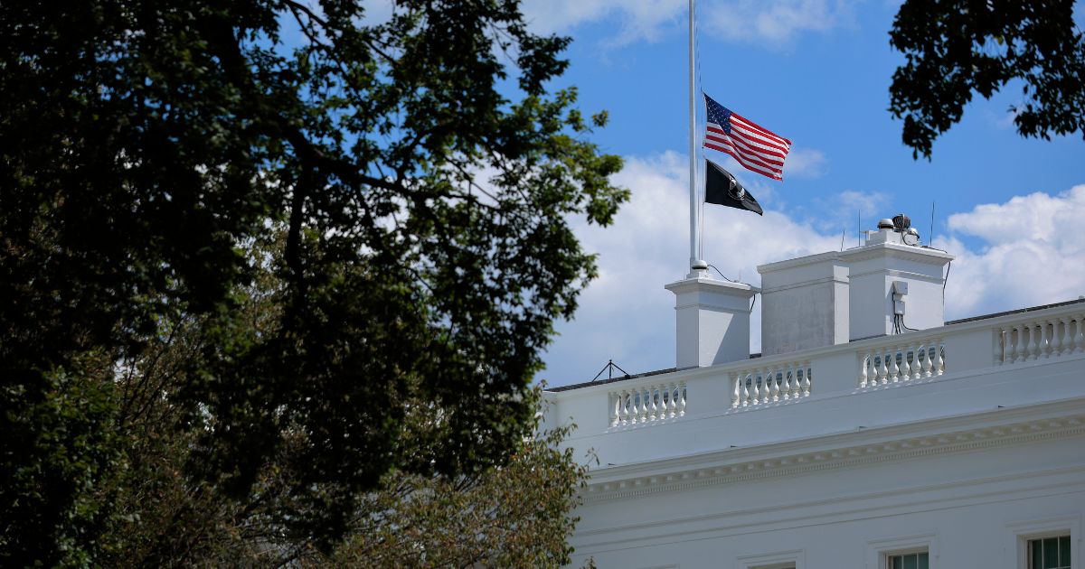 The U.S. flag is lowered to half-staff above the White House Wednesday in Washington, D.C.