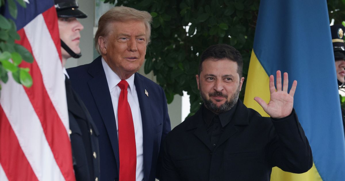 President Donald Trump and Ukrainian President Volodymyr Zelensky stand between the U.S. and Ukranian flags as they speak to reporters at the White House Monday.