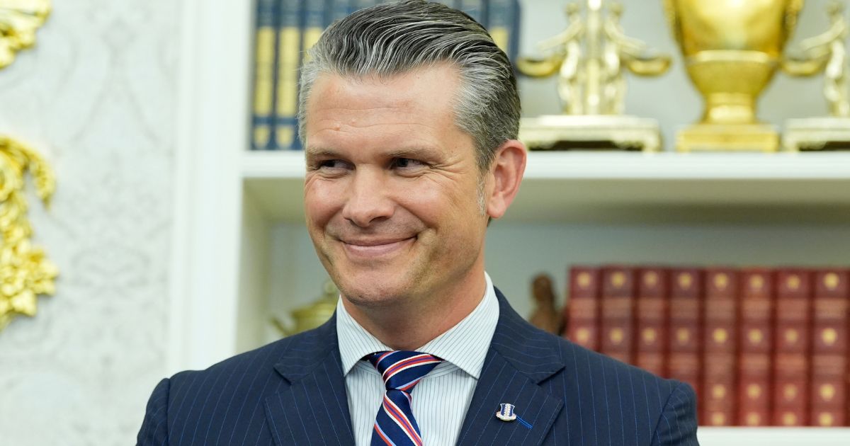 Defense Secretary Pete Hegseth listens as President Donald Trump speaks during an event signing a proclamation honoring the fourth anniversary of the attack at Abbey Gate in Afghanistan in the Oval Office at the White House in Washington, D.C., on Aug. 25.