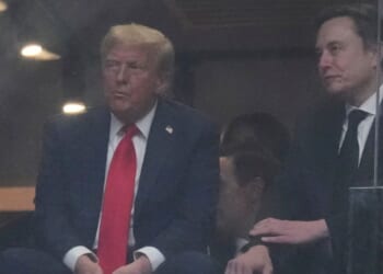 President Donald Trump, left, and Elon Musk, right, listen during a memorial for Charlie Kirk in Glendale, Arizona, on Sunday.