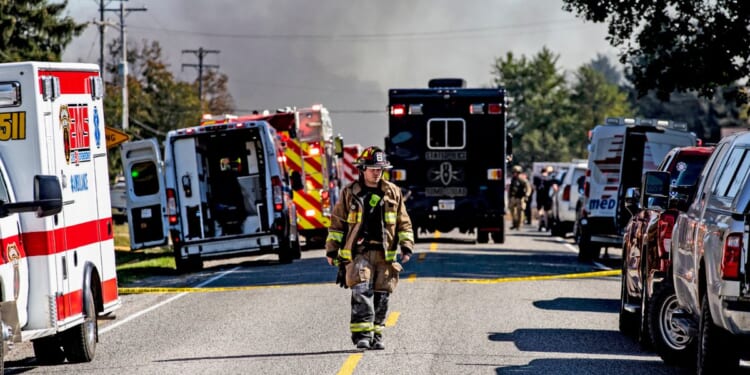 A firefighter walks down the street near the Church of Jesus Christ of Latter-day Saints that was attacked on Sept. 28, 2025 in Grand Blanc, Michigan.