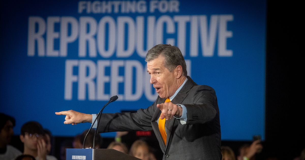North Carolina Gov. Roy Cooper is seen in a 2024 photo addressing a crowd during a national "Reproductive Freedom Bus Tour" event by the campaign of Democratic presidential nominee Vice President Kamala Harris and running mate Gov. Tim Walz.