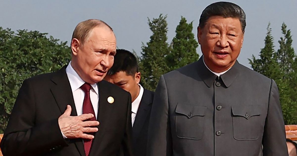 Russian President Vladimir Putin, left, walks with China's President Xi Jinping Wednesday in Beijing's Tiananmen Square.