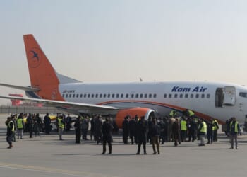 Kam Air employees gather by an airplane at a ceremony for Ukrainian employees of the Afghan airline at Kabul International Airport on Jan. 24, 2018, following their deaths in a Taliban attack on the Intercontinental Hotel.