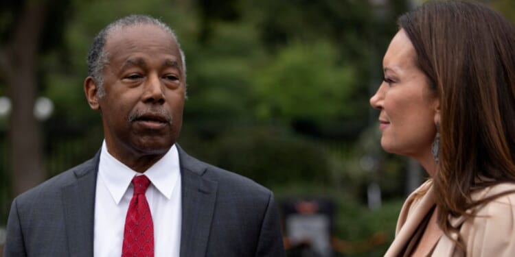 Ben Carson speaks with reporters as Agriculture Secretary Brooke Rollins listens outside the White House in Washington, D.C., on Wednesday.