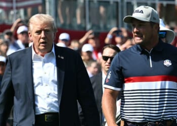 President Donald Trump walks with pro golfer Bryson DeChambeau as he attends the 2025 Ryder Cup at Black Course at Bethpage State Park Golf Course on Sept. 26, 2025, in Farmingdale, New York.