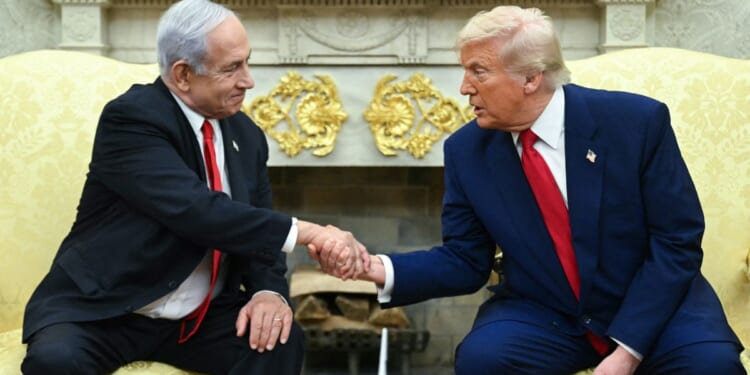 Israeli Prime Minister Benjamin Netanyahu, left, and President Donald Trump, right, shake hands during a meeting in the Oval Office of the White House in Washington, D.C., on April 7.