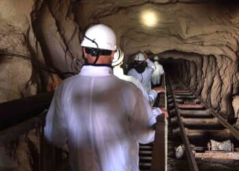 In a file photo from July 29, 2019, visitors walk down the inclined shaft at Steenkampskraal (SKK) rare-earth mine about 50 miles from the South African town of Vanrhynsdorp. SKK has been confirmed as one of the highest grade deposits of rare-earth minerals in the world. The rare-earth minerals are used in the manufacture of powerful magnets, which are used in electric vehicles, wind turbines, robotics, and many other applications.