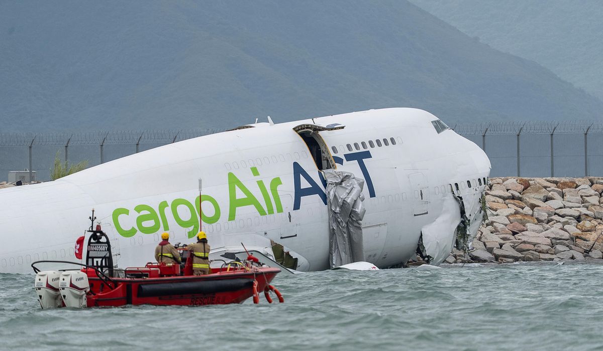 A cargo aircraft skids off a Hong Kong runway into the sea, killing two airport workers