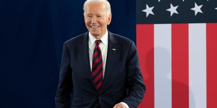 Ex-President Joe Biden rings the bell after completing radiation therapy for cancer