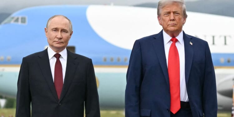 President Donald Trump and Russian President Vladimir Putin pose on a podium at Joint Base Elmendorf-Richardson in Anchorage, Alaska, on Aug. 15.