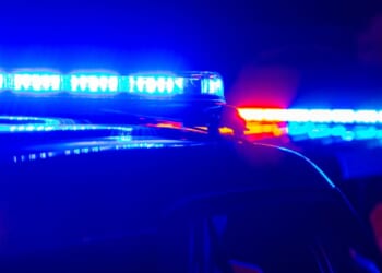 The blue and red police lights at a crime scene in a generic stock photograph.