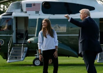 President Donald Trump and his granddaughter, Kai Trump, walk to Marine One on the South Lawn of the White House as they prepare to depart on Sept. 26, 2025, in Washington, D.C.