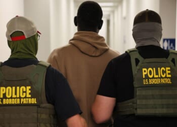 Federal agents detain a man after his court hearing in immigration court at the Ted Weiss Federal Building in New York City on July 9.