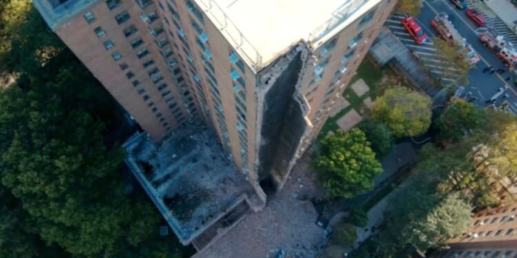 A high-rise apartment building partially collapsed after a suspected gas explosion in New York City on Wednesday.
