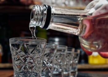 Crystal shot glasses of vodka standing in a row.