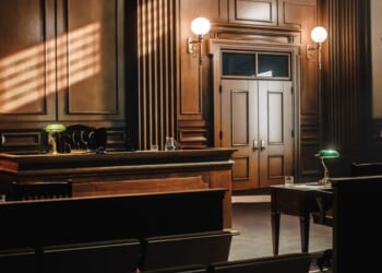 This stock image shows an empty courtroom.