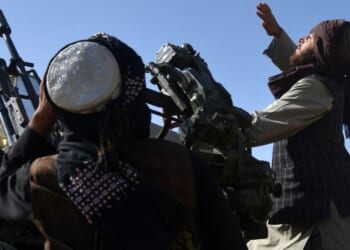 Armed Taliban forces watch the sky for Pakistani airstrikes during ongoing clashes between Taliban forces and Pakistani border forces in the Kandahar Province on Wednesday.