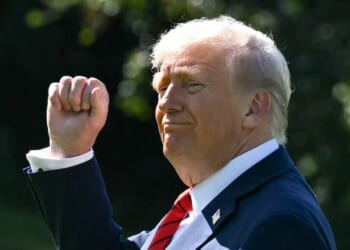 President Donald Trump raises his fist on the South Lawn of the White House in Washington, DC on Oct. 10, 2025.