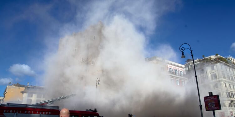 Rescuers working to reach worker trapped in medieval tower that partially collapsed in Rome