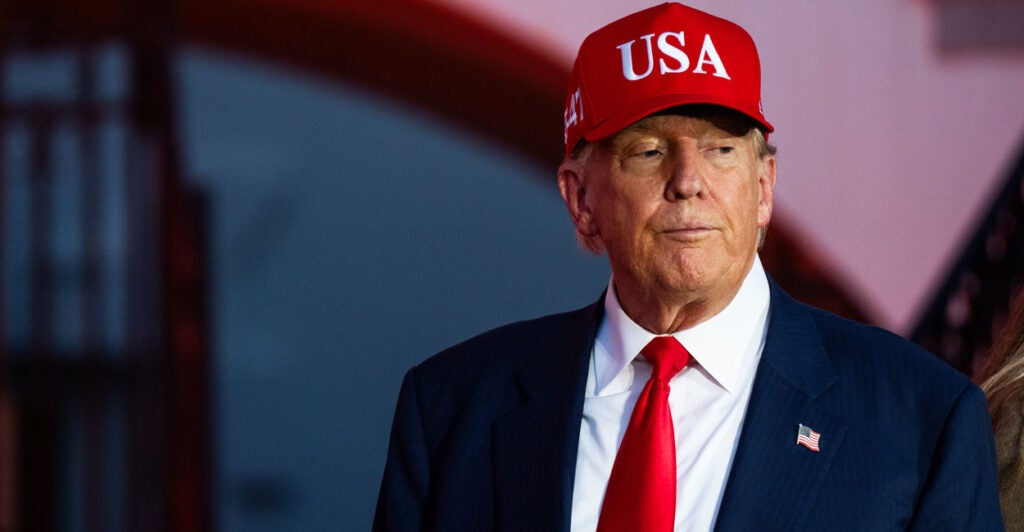 President Donald Trump stands in front of the White House at a Halloween event.