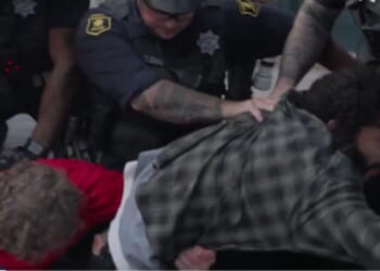An antifa-linked man, right, and Trump supporter, left, are arrested by police at UC Berkeley at a Turning Point USA event on Monday.