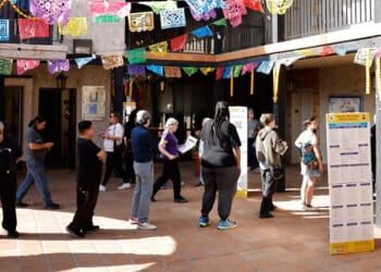 Voters wait in line to enter a polling place in Los Angeles, California, on Tuesday.