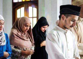 A muslim prayer takes place at a mosque.
