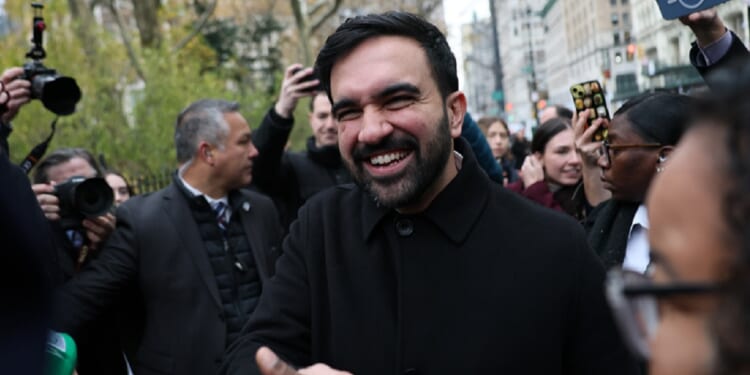 New York City Mayor-elect Zohran Mamdani gladhands supporters after a Thursday news conference in New York.