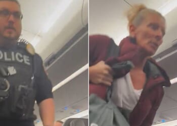 The disruptive passenger was escorted off the plane in Kansas City.