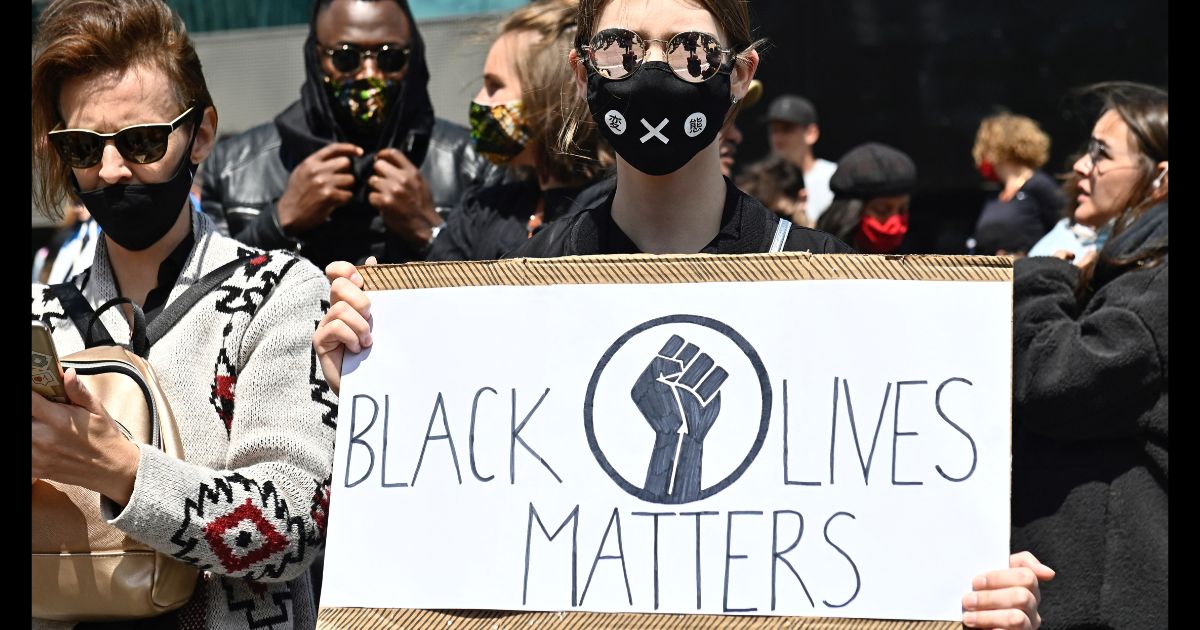A protester holds up a sign that says "Black Lives Matter" at a protest in Berlin on June 6, 2025.