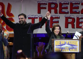 New York City Mayor-elect Zohran Mamdani holds hands with New York Gov. Kathy Hochul on stage during a campaign rally at Forest Hills Stadium in the Queens borough of New York City on Oct. 26, 2025.