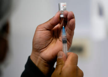 A health care worker prepares a shot of the Pfizer COVID-19 vaccine in La Paz, Bolivia, in a file photo taken Jan. 7.