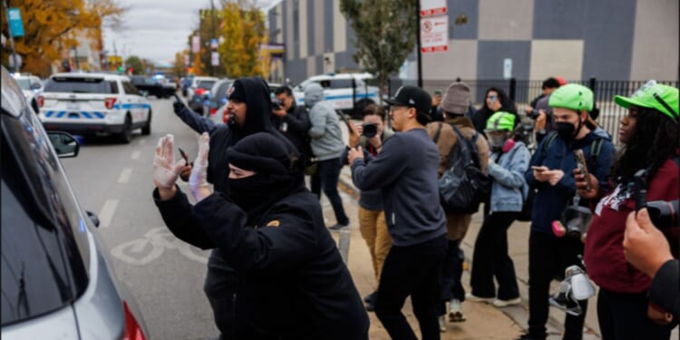 Protesters confronted immigration officers in the Little Village neighborhood of Chicago Saturday.