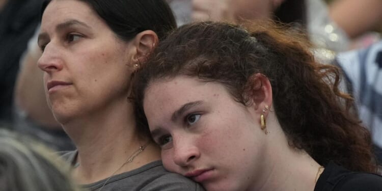 Gatherers at Bondi Beach mourn victims of antisemitic attack