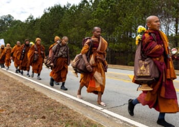Buddhist monks persevere in peace walk despite injuries as thousands follow them on social media