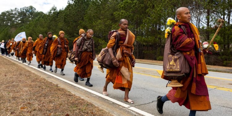 Buddhist monks persevere in peace walk despite injuries as thousands follow them on social media